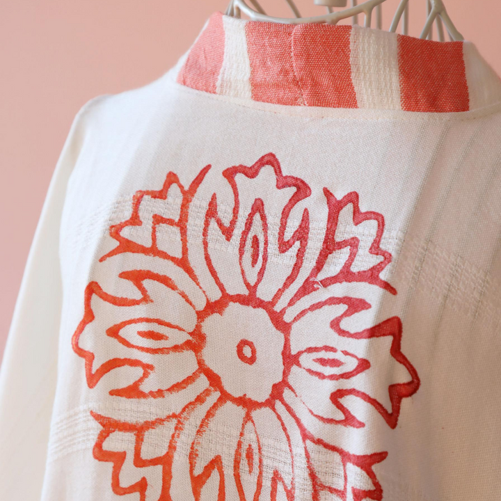 orange floral print at the back of the women dress made by wood-block printing method